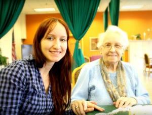 NWU student Becca Brune visits with an elderly woman
