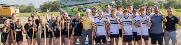 A group of NWU softball and baseball players and coaches with shovels.